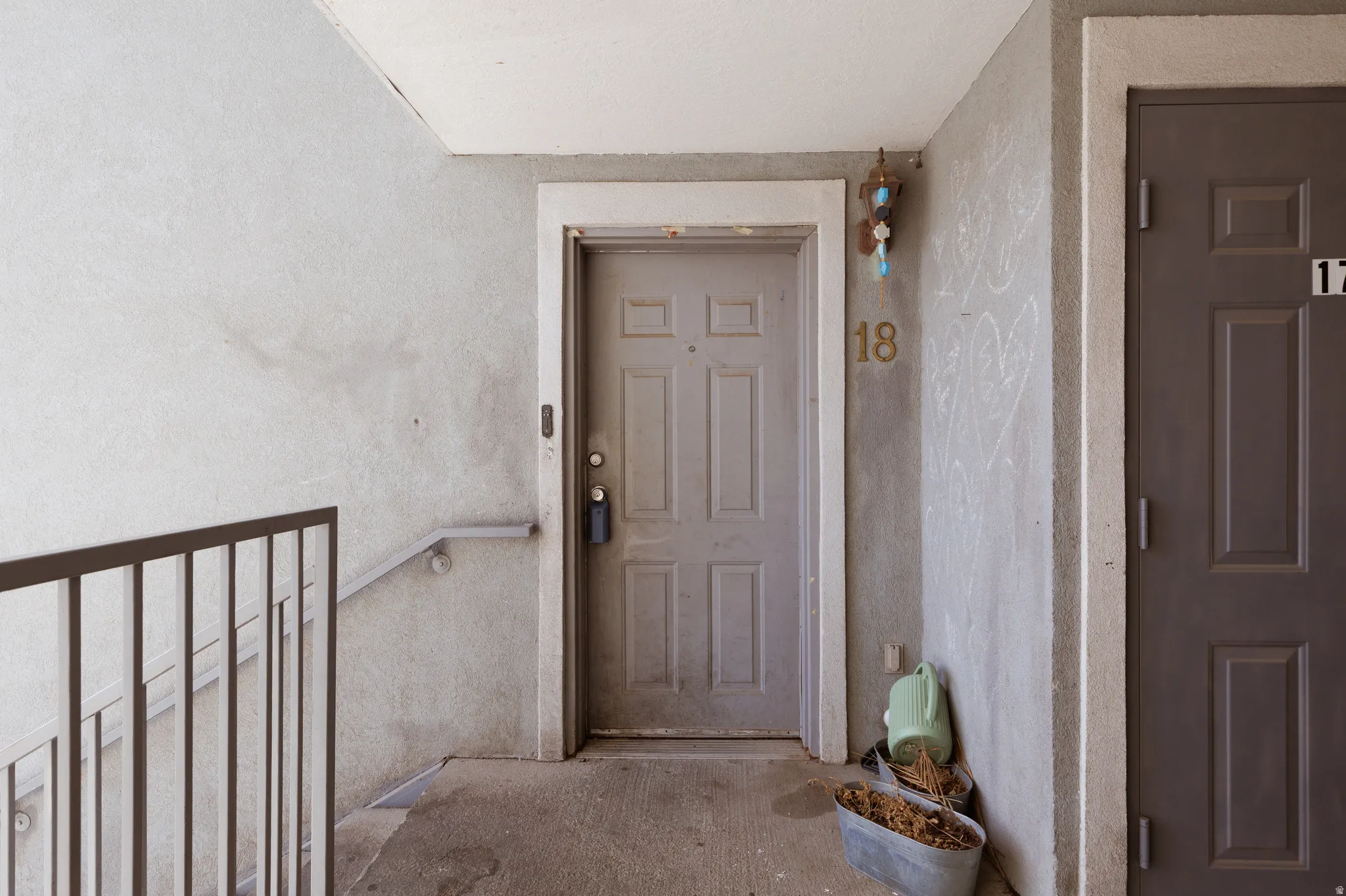View of exterior entry with stucco siding