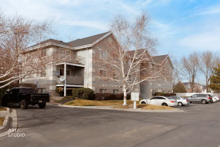 View of front of home with stone siding and uncovered parking