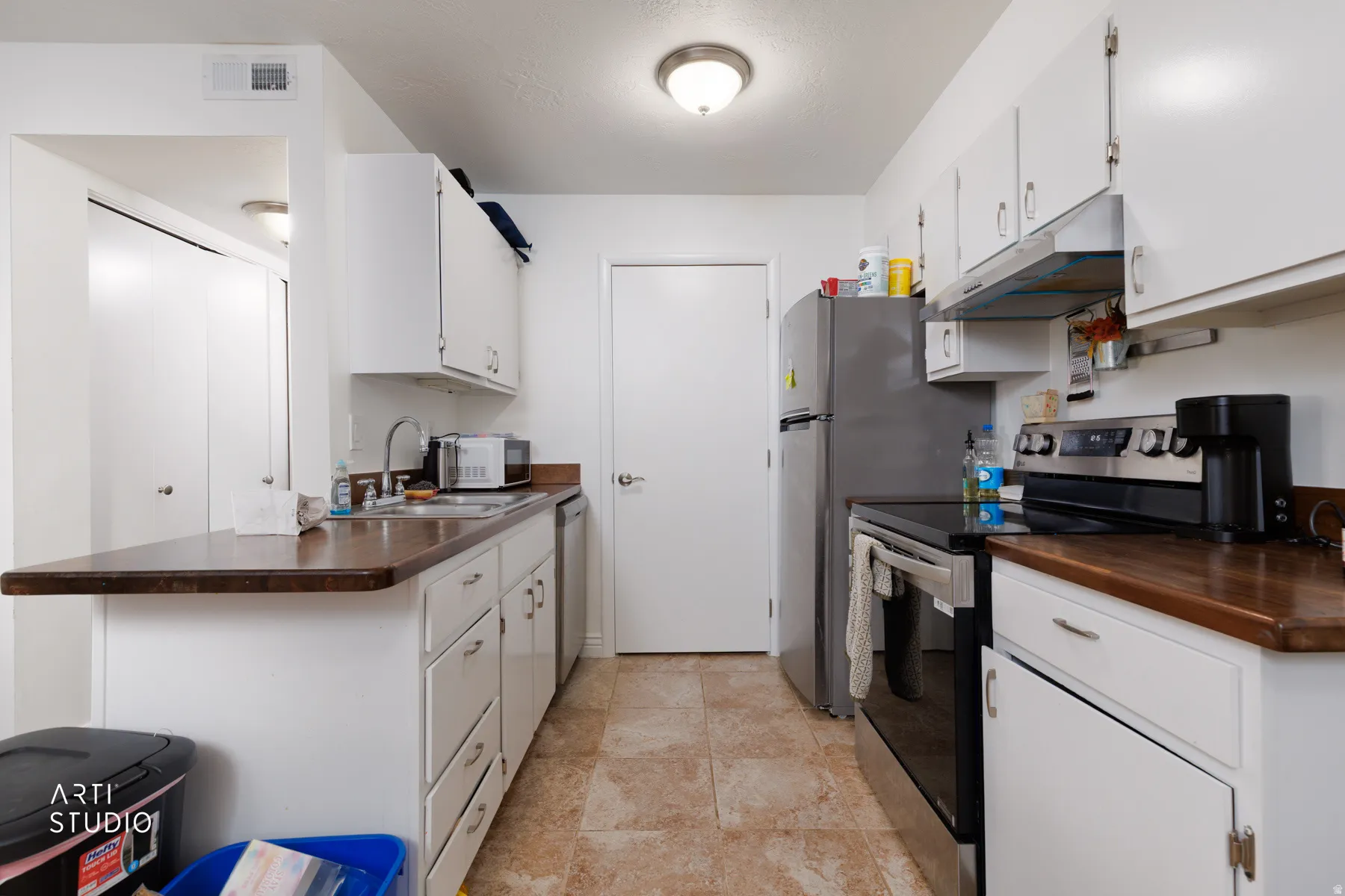 Kitchen with stainless steel appliances and white cabinets