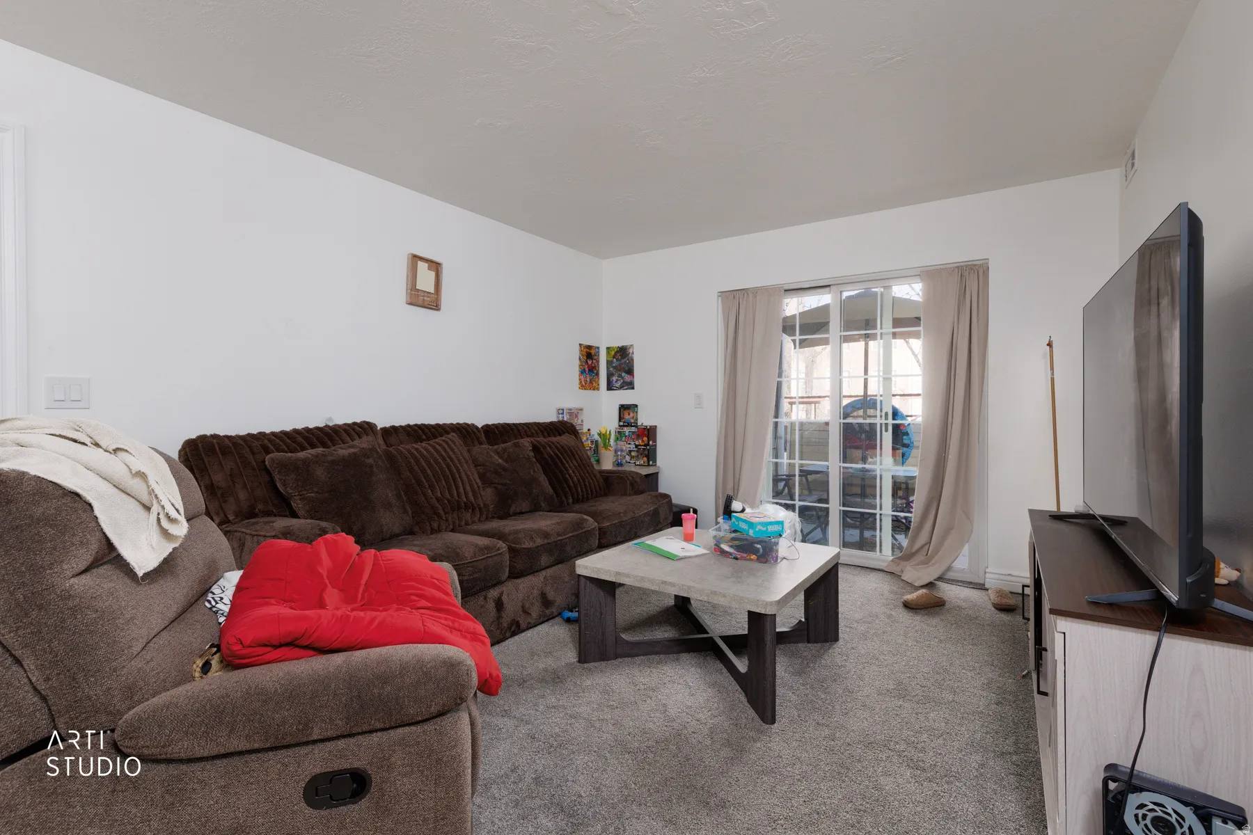 Living area featuring light colored carpet