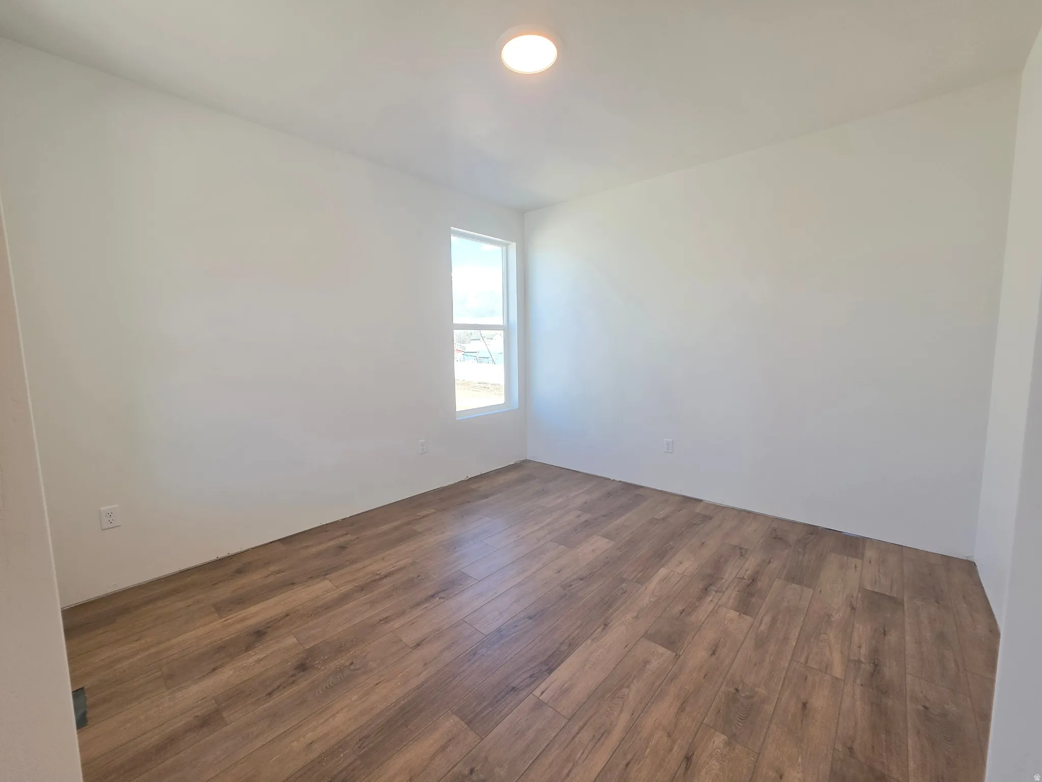 Empty room with dark wood-type flooring