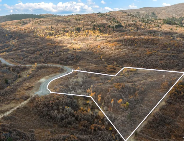 Aerial view of sparsely populated area with property parcel outlined