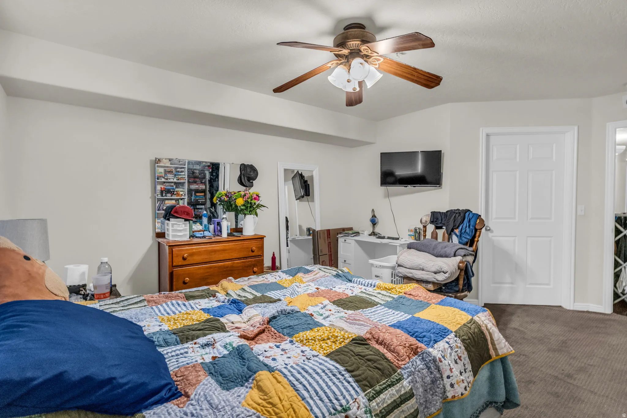 Carpeted bedroom with ceiling fan