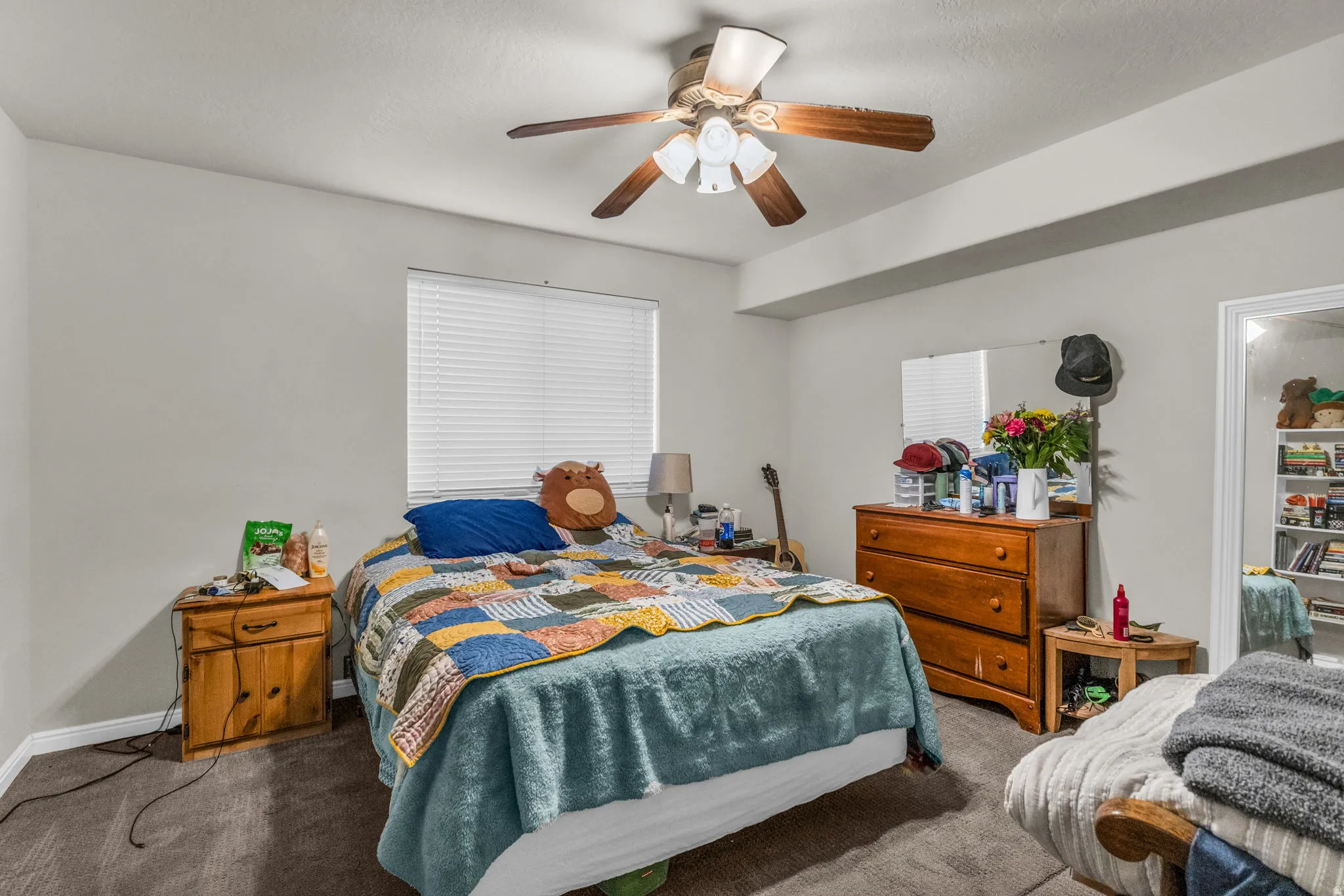 Bedroom featuring dark colored carpet and a ceiling fan