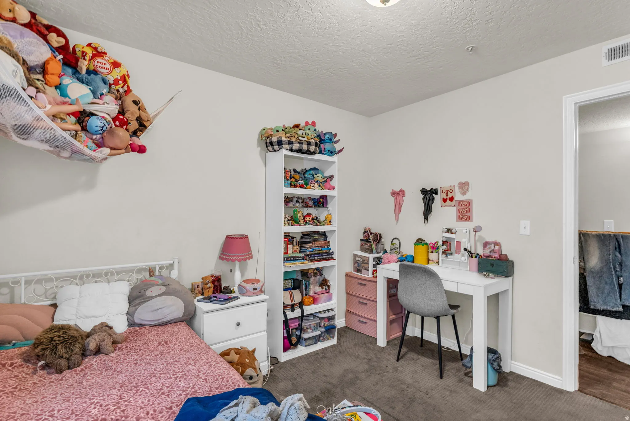 Bedroom with carpet and a textured ceiling