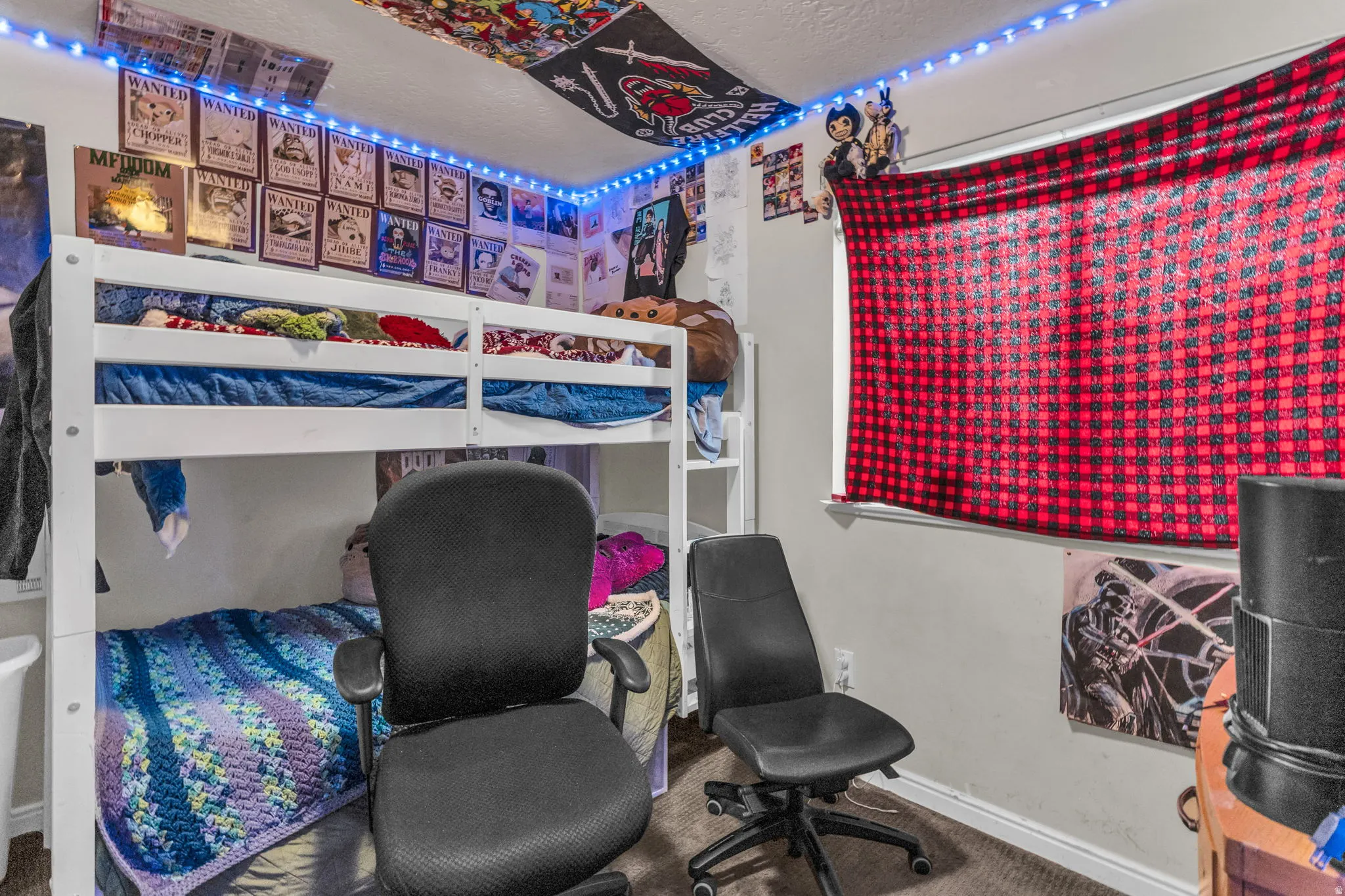 Carpeted bedroom featuring baseboards and a textured ceiling