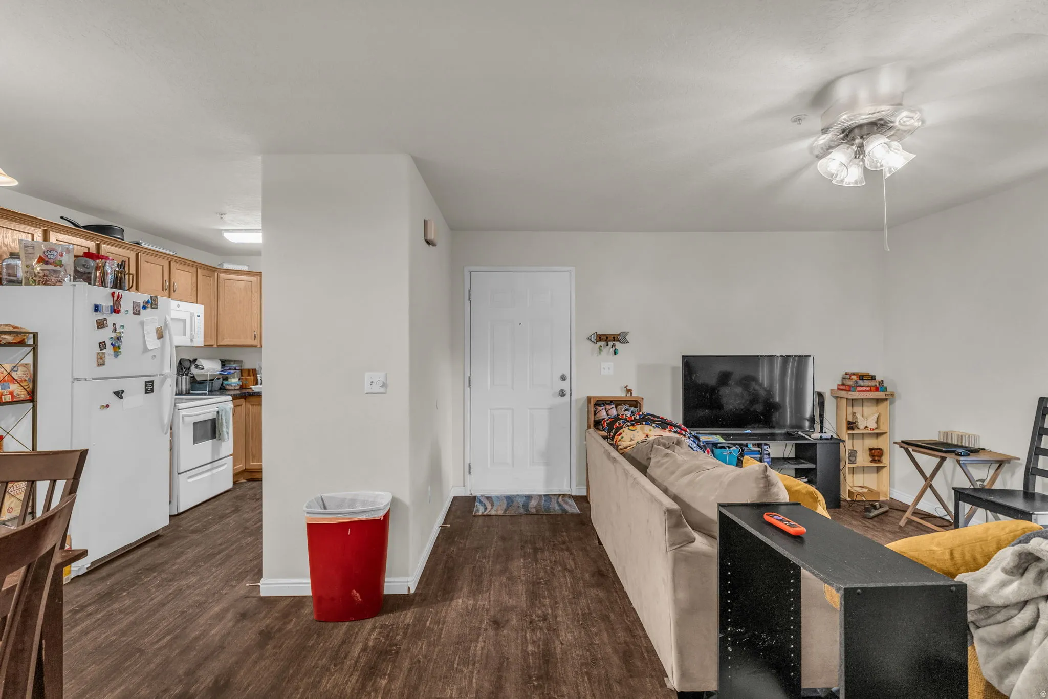 Living room featuring dark wood finished floors and baseboards