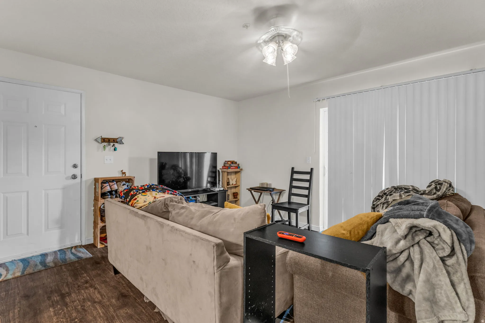 Living room with dark wood-type flooring