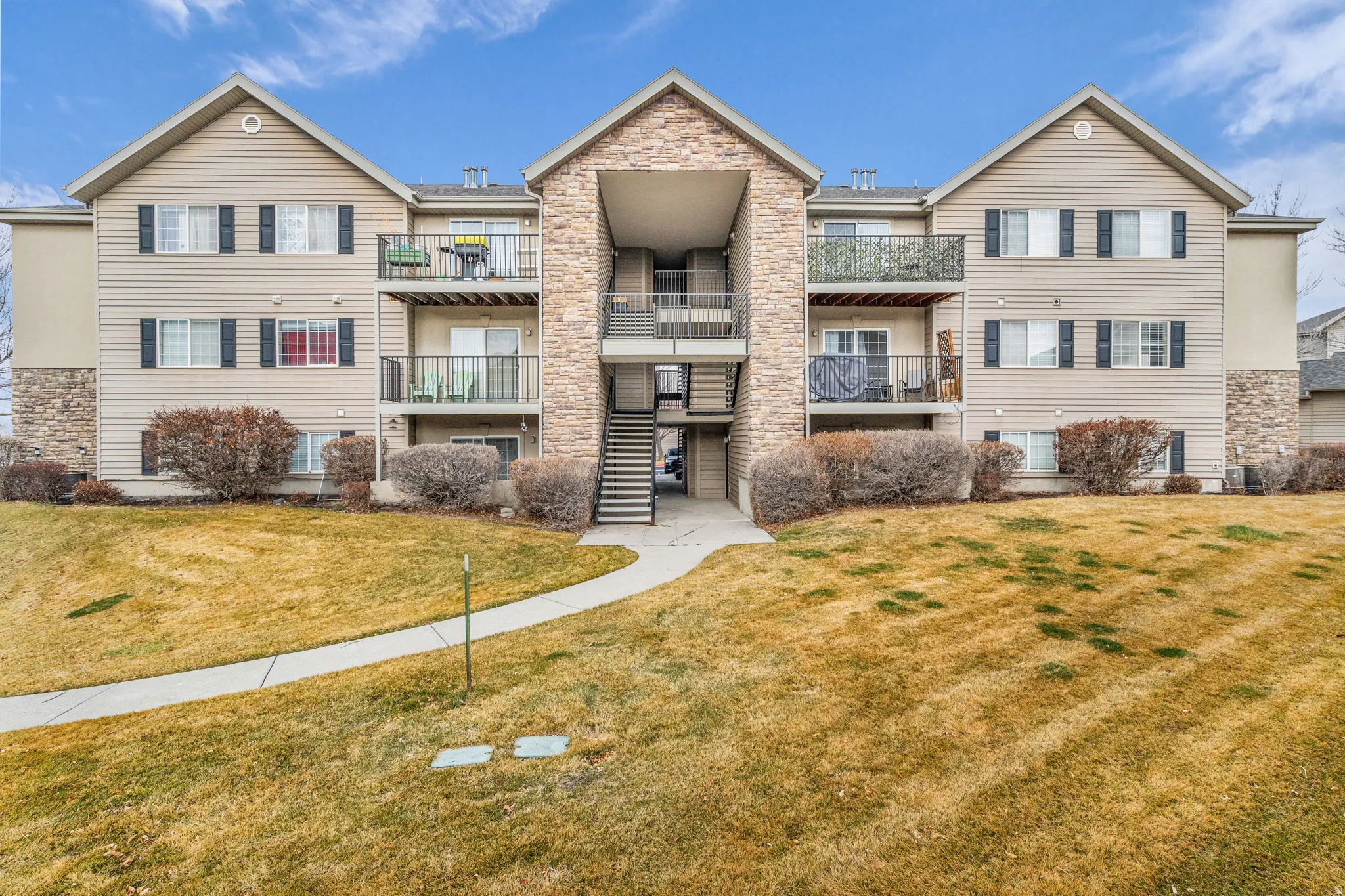View of apartment building / complex featuring stairs