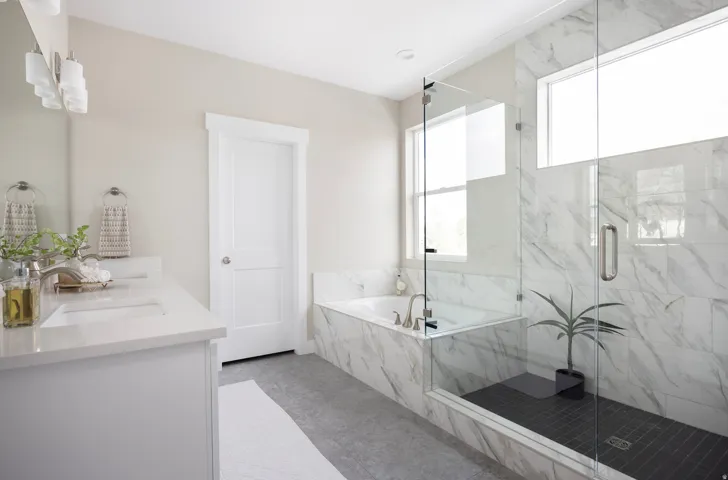 Full bath with a bath, a marble finish shower, double vanity, and light tile patterned floors