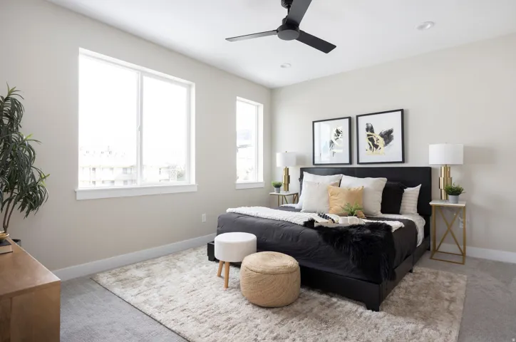 Carpeted bedroom with baseboards and ceiling fan