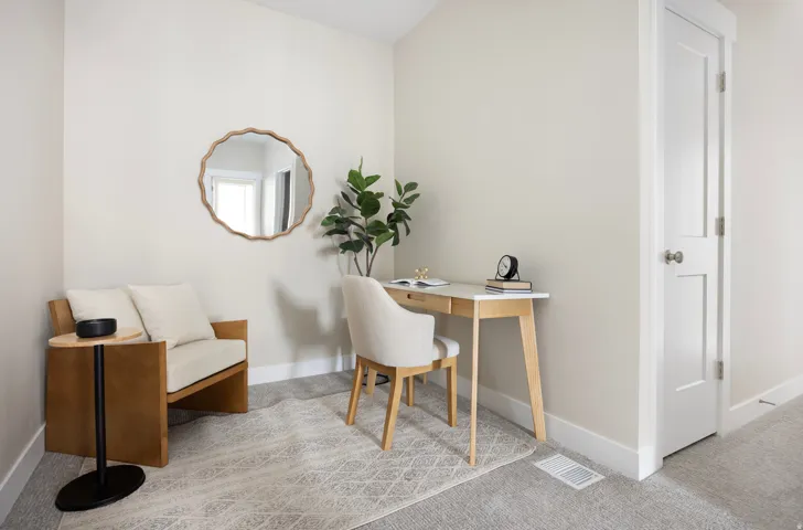 Office area featuring light colored carpet and baseboards