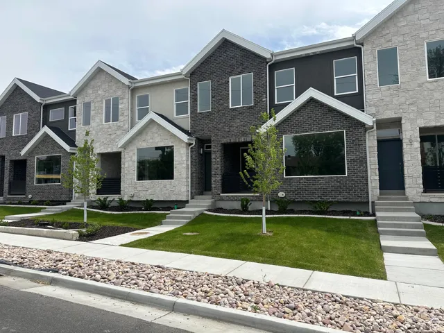 Contemporary townhome exteriors featuring varied stone and brick facades