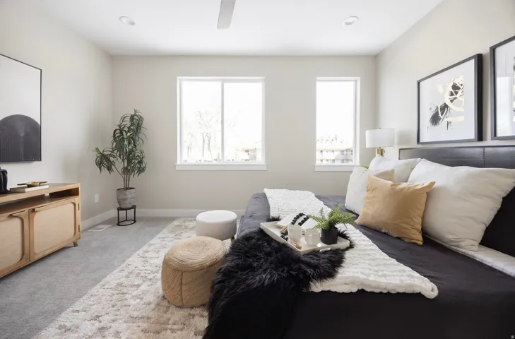 Carpeted bedroom featuring baseboards and ceiling fan