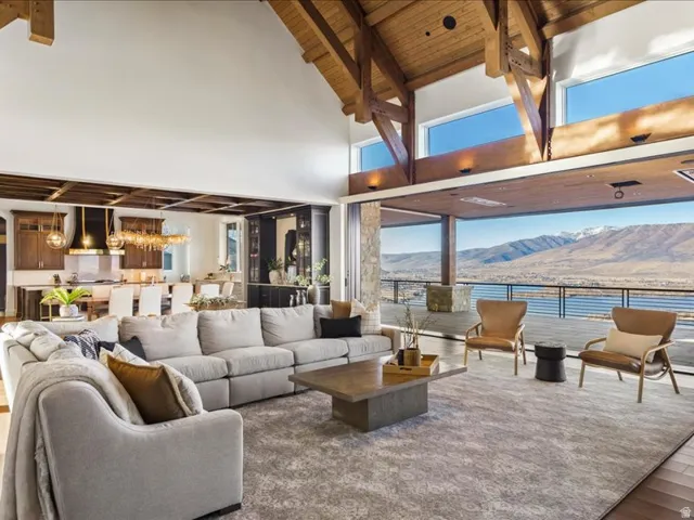 Living room featuring a mountain view, a high wooden beamed ceiling, and wood finished floors