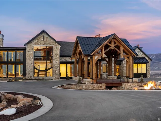 View of building exterior featuring an outdoor fire pit