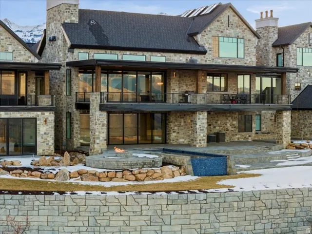 Back of house featuring a balcony and a patio