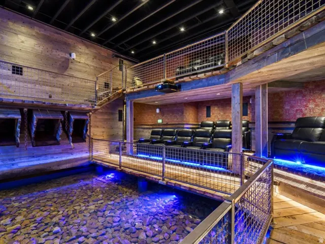 Rec room featuring a high ceiling and wooden walls