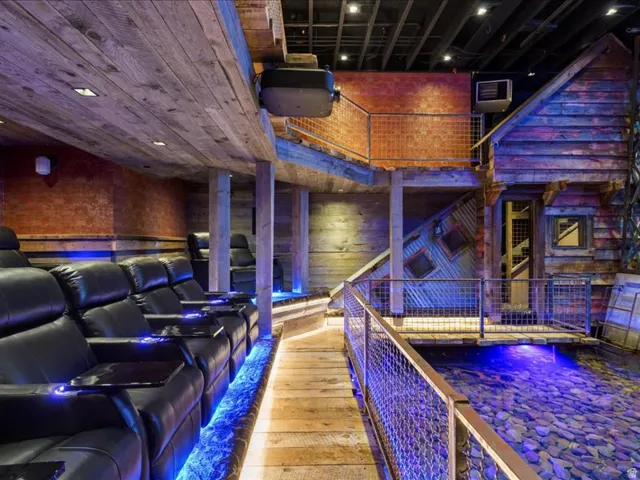 Home theater featuring hardwood / wood-style flooring and a high ceiling