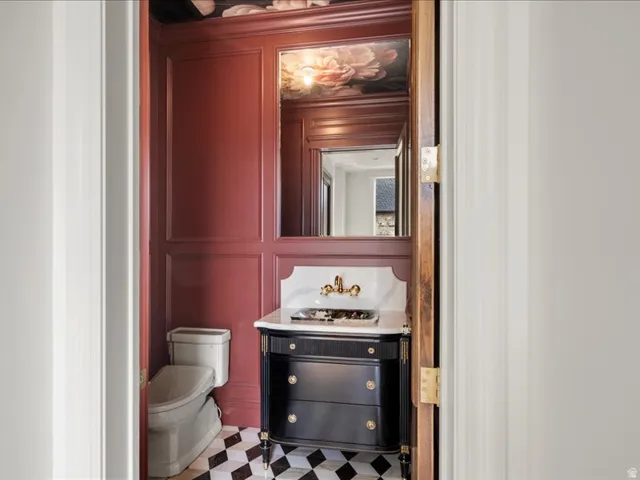 Half bathroom with vanity and tile patterned floors
