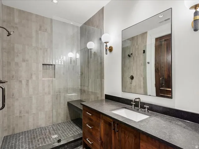 Full bath with vanity and a stall shower