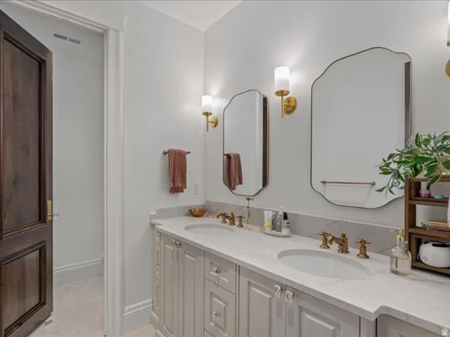 Full bath with double vanity and toilet