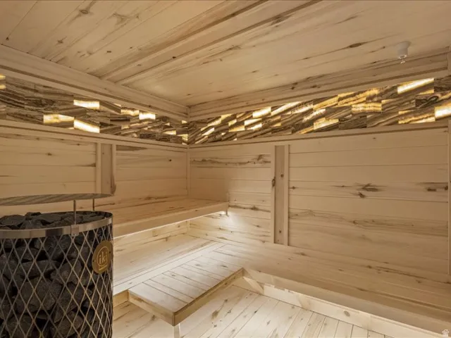 Relaxing sauna / steam room featuring wooden ceiling and wood walls
