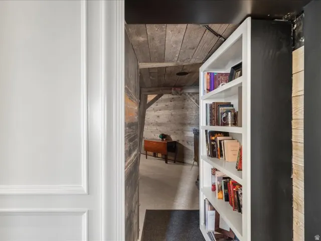 Hall featuring concrete flooring and wood walls