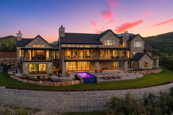 Stone and wood-clad exterior with multiple balconies and terraces