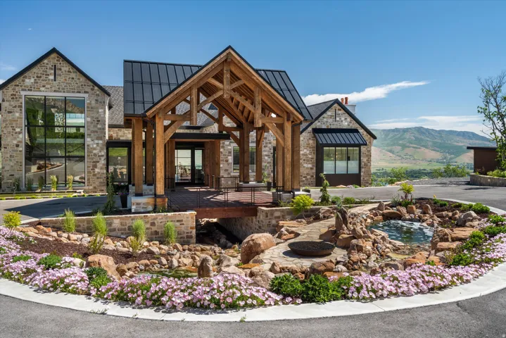 Stone facade residence featuring a prominent timber-frame portico