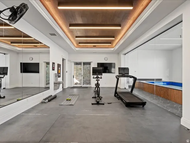 Workout area featuring a wooden tray ceiling