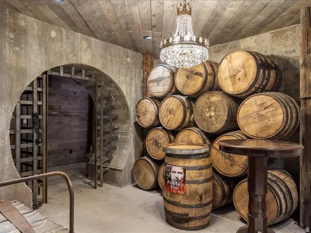 Wine room with a chandelier and concrete flooring