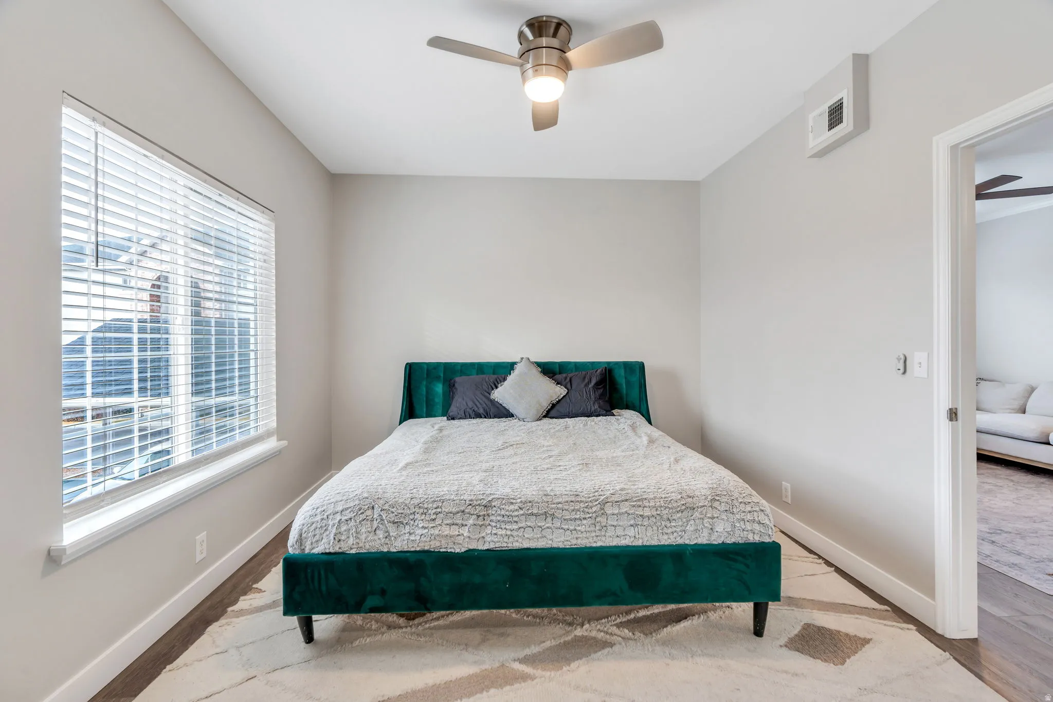 Bedroom featuring wood finished floors and ceiling fan