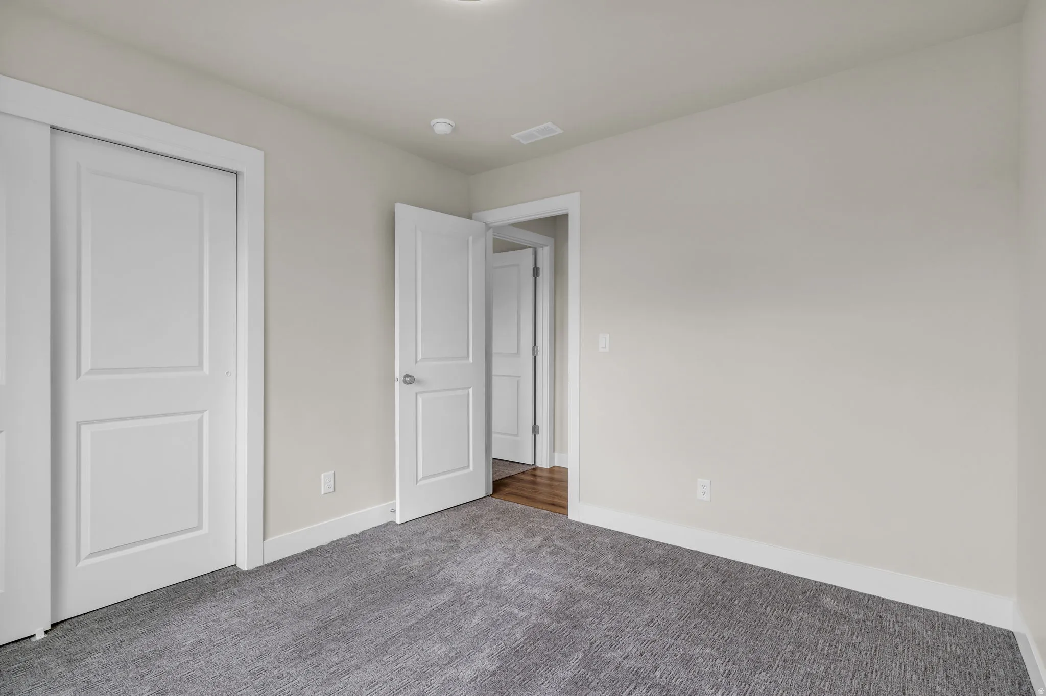 Unfurnished bedroom featuring carpet flooring and a closet