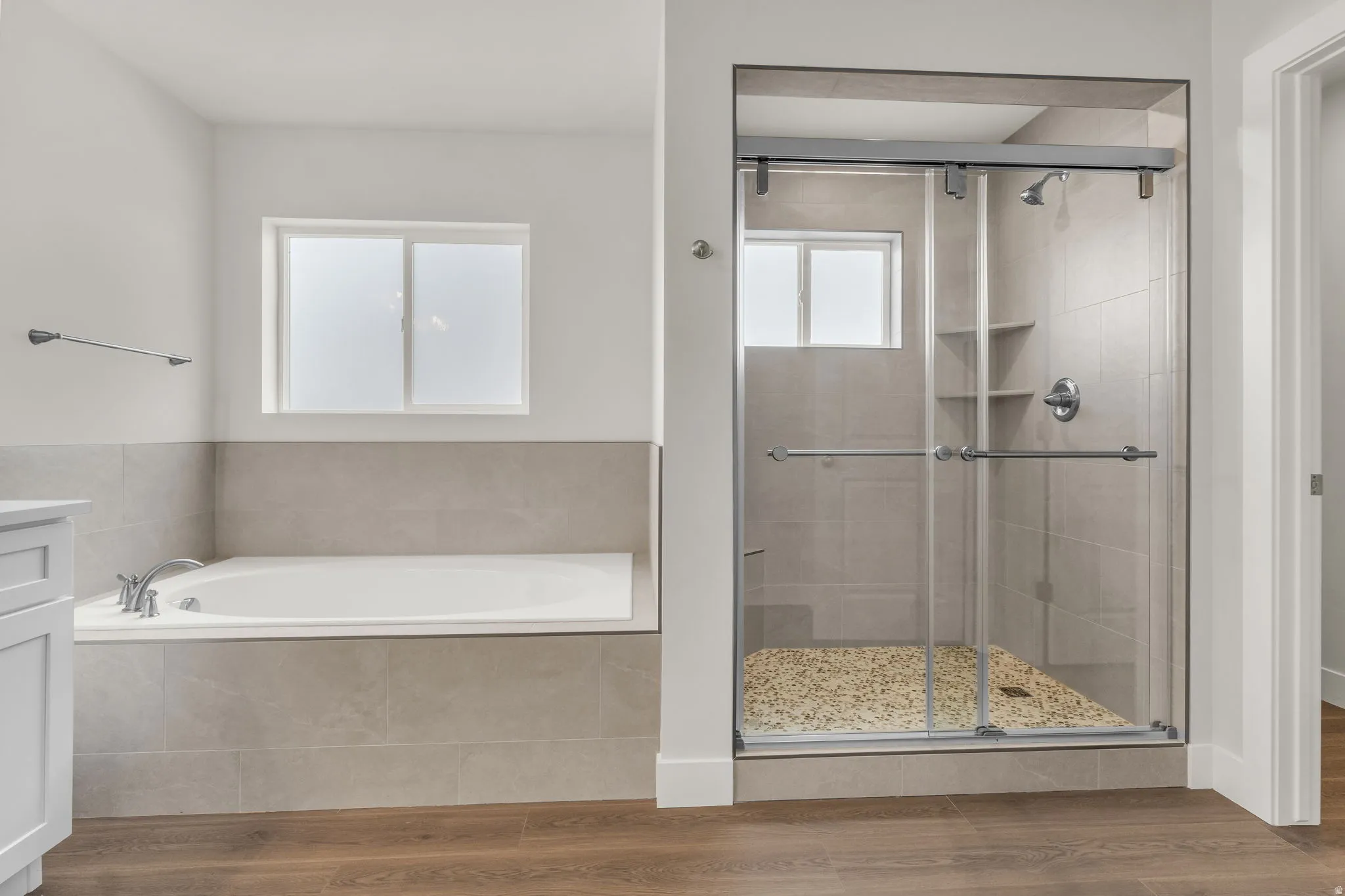 Full bathroom featuring vanity, a bath, wood finished floors, and a shower stall