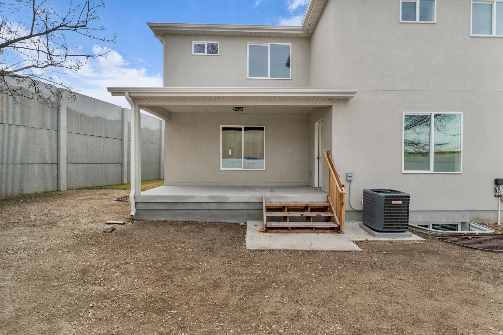 Rear view of property featuring stucco siding and a patio