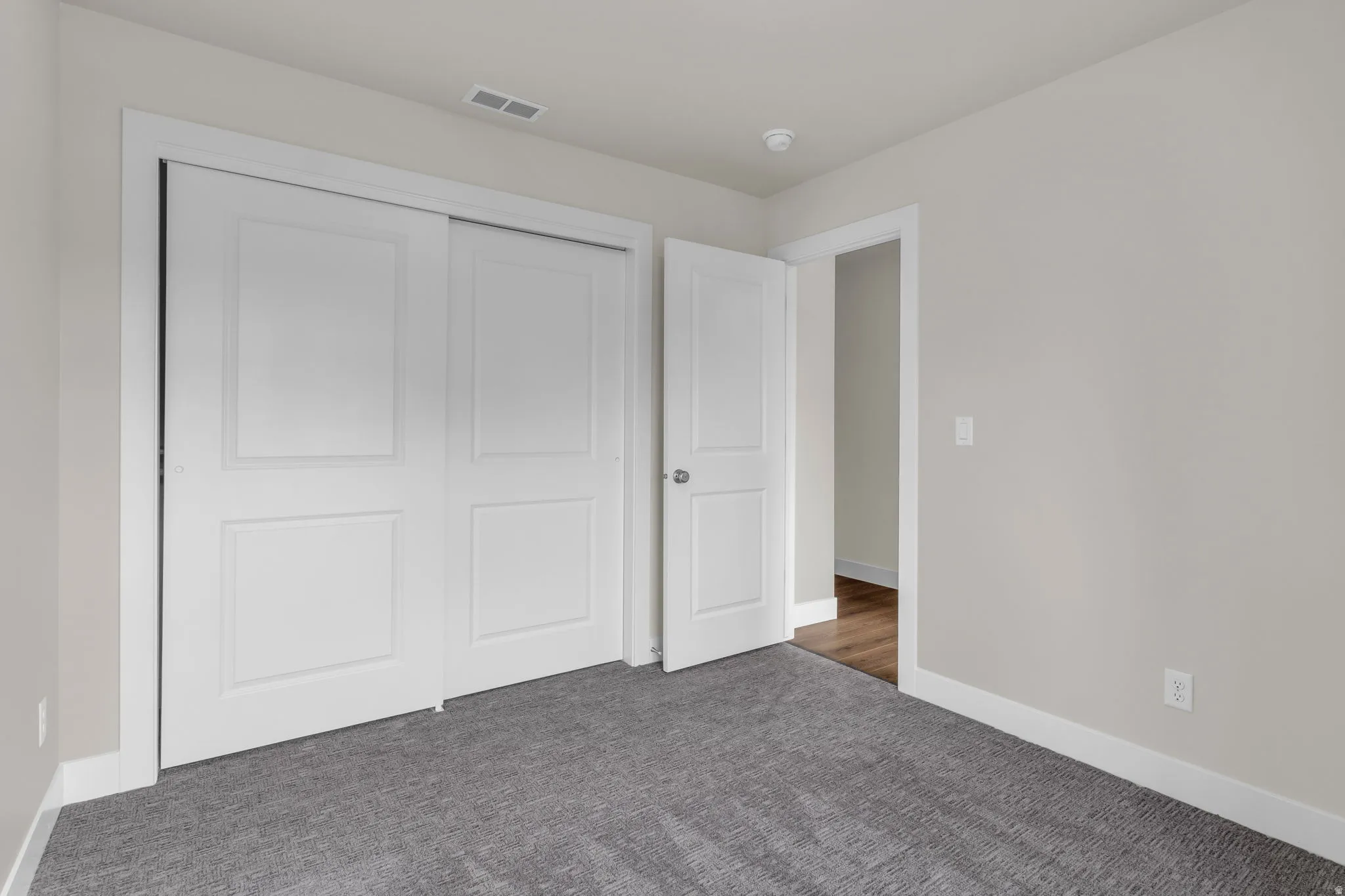 Unfurnished bedroom featuring carpet flooring and a closet