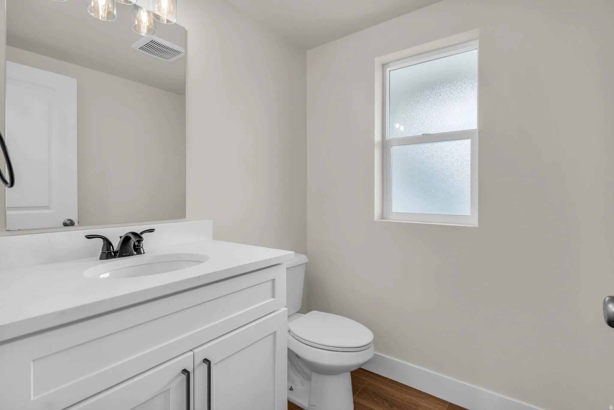 Bathroom with vanity and wood tiled floors