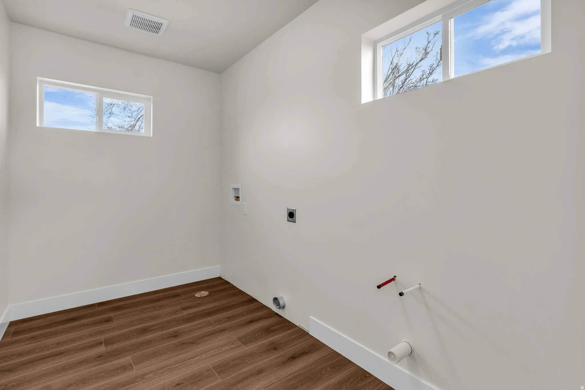 Laundry room featuring hookup for a washing machine, dark wood-style flooring, and hookup for an electric dryer