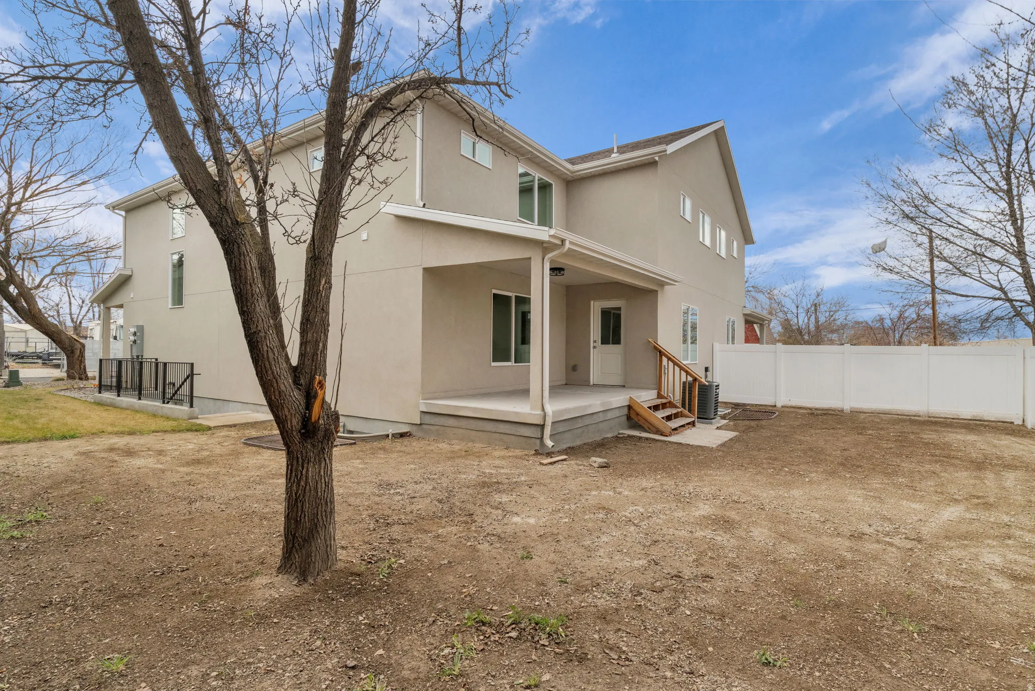 Rear view of house with stucco siding