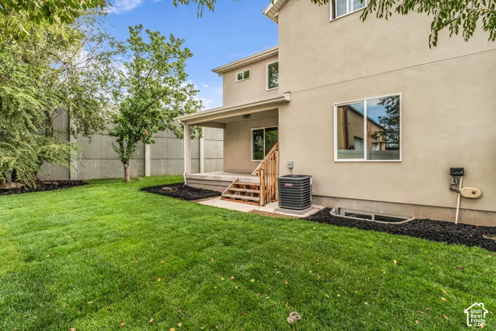 Expansive green space with a covered patio and direct exterior access
