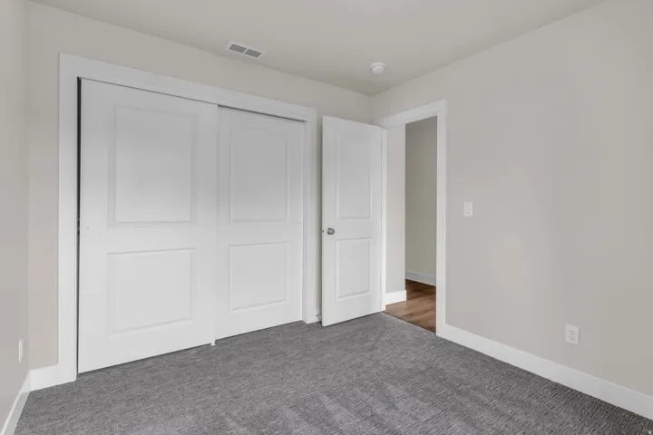 Unfurnished bedroom featuring carpet flooring and a closet