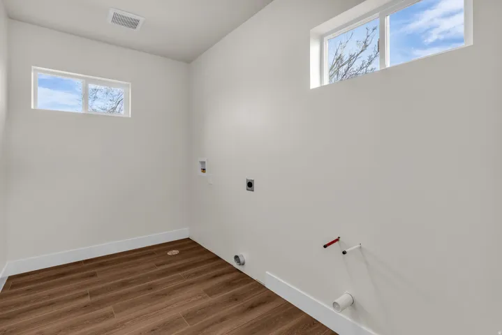 Laundry room featuring hookup for a washing machine, dark wood-style flooring, and hookup for an electric dryer