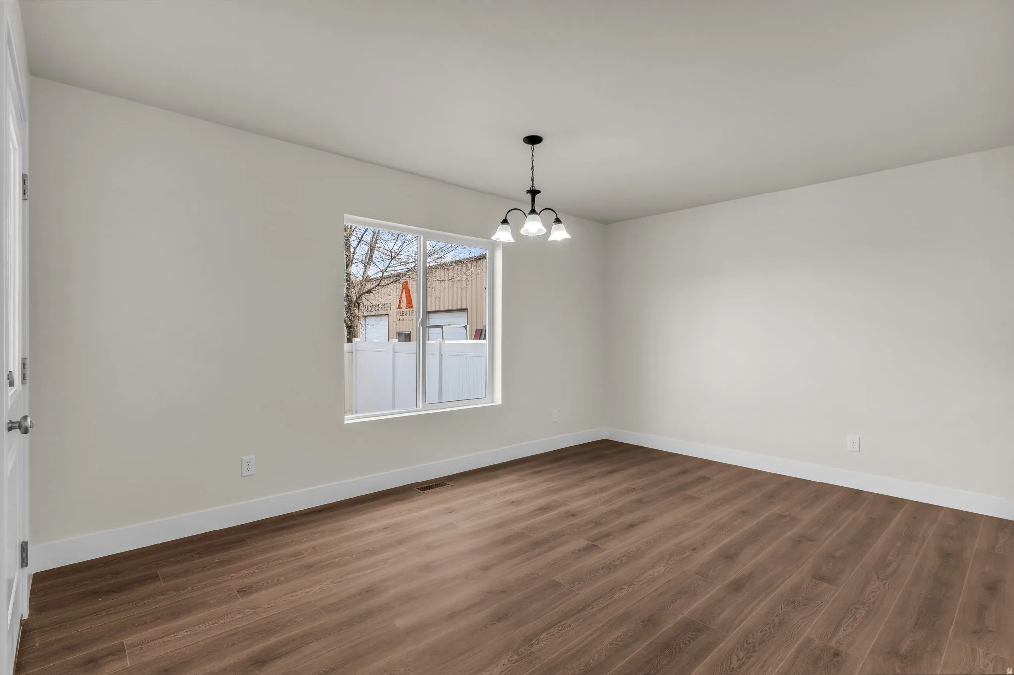 Unfurnished dining area with dark wood-style flooring and a chandelier