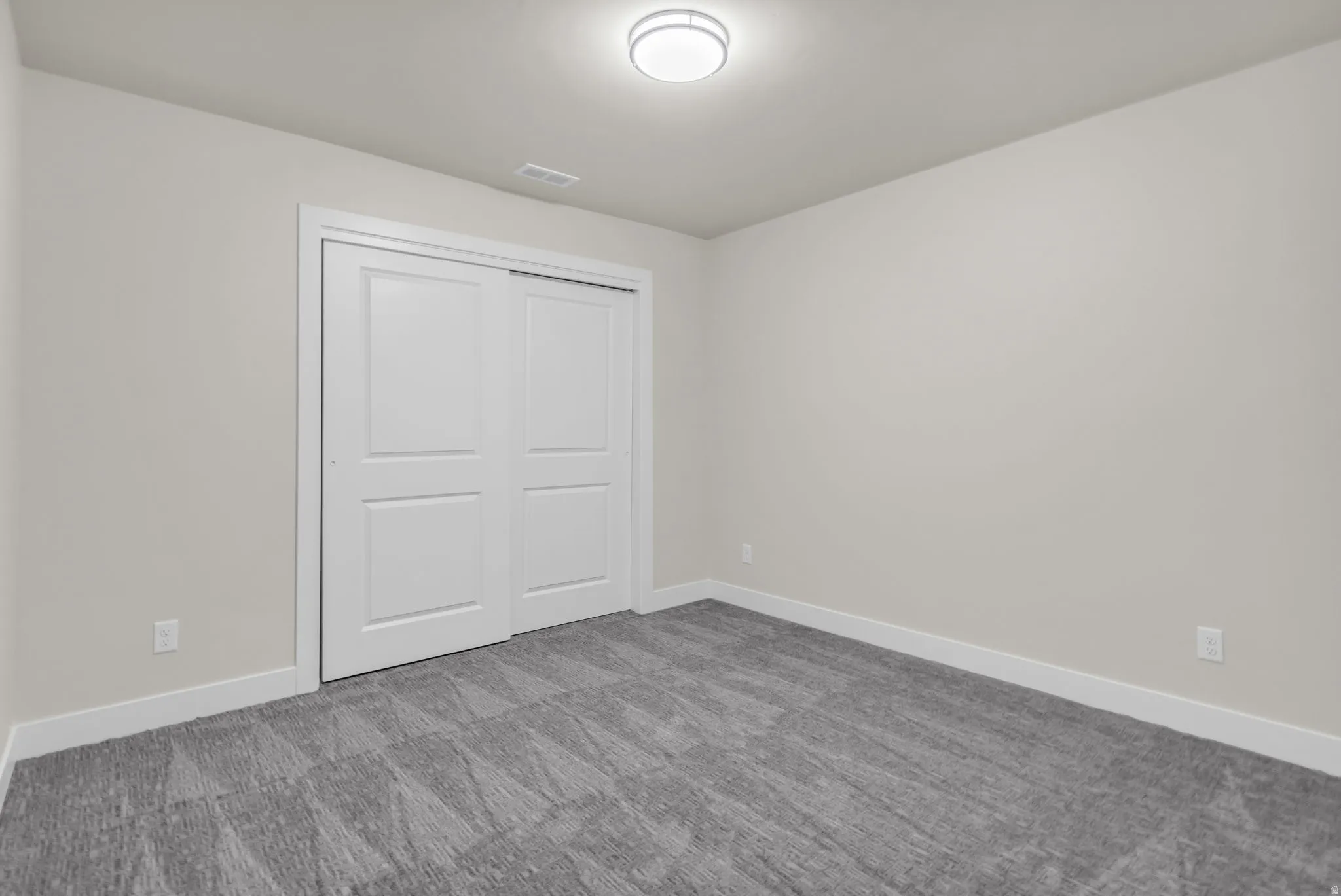 Unfurnished bedroom featuring a closet and carpet flooring