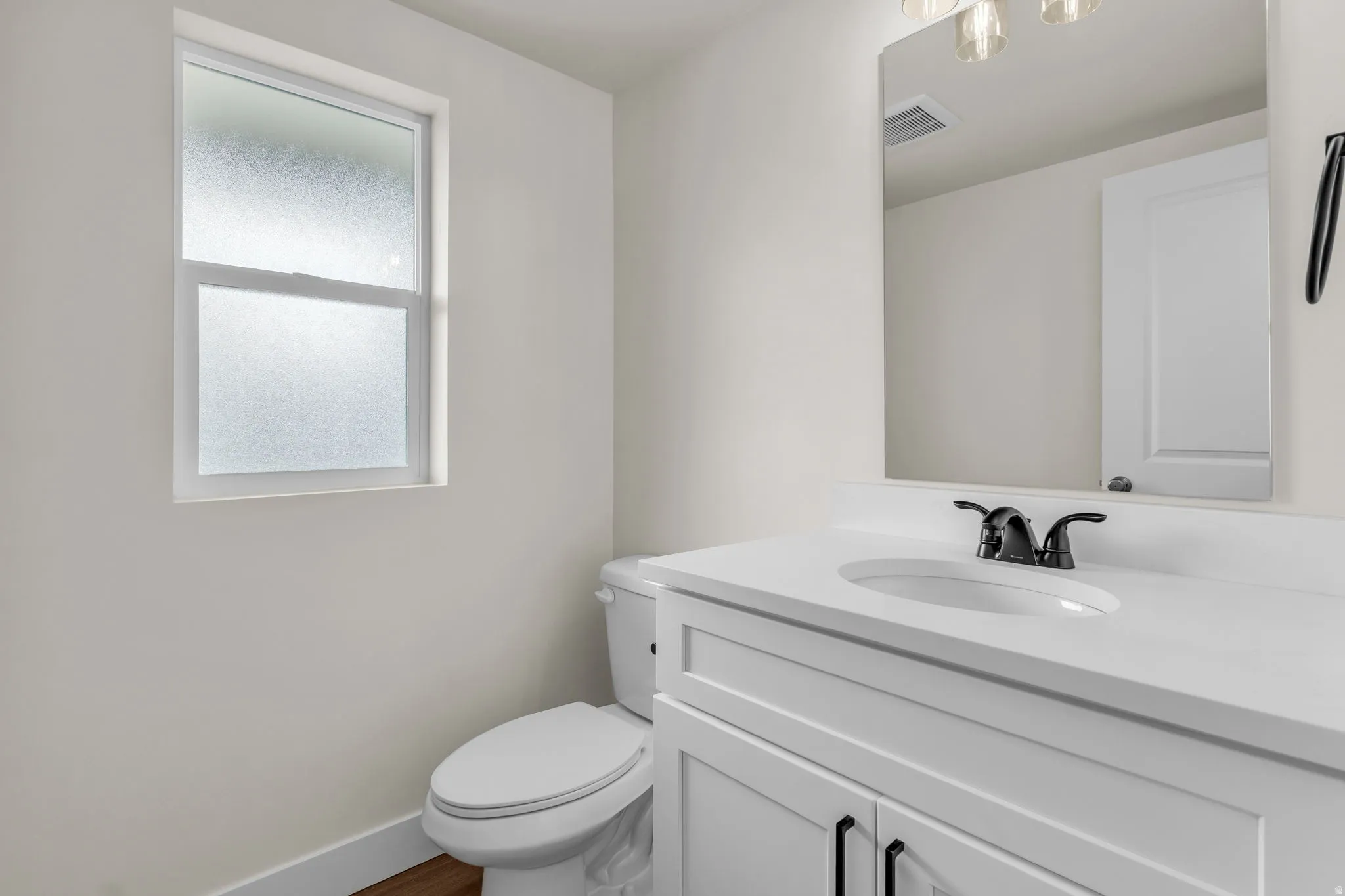 Half bath with toilet and vanity