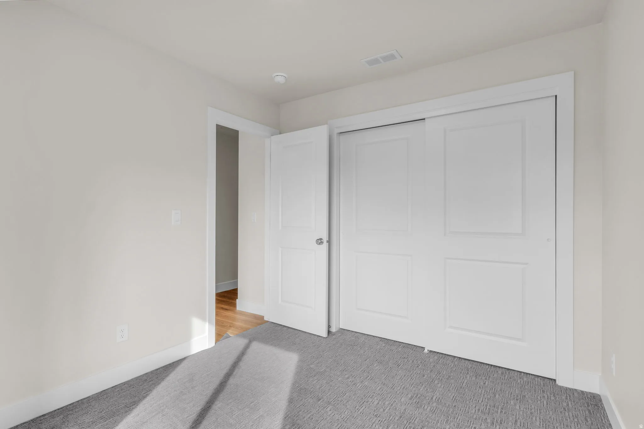 Unfurnished bedroom featuring carpet floors and a closet