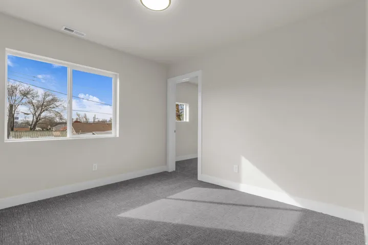 Unfurnished bedroom featuring carpet and baseboards