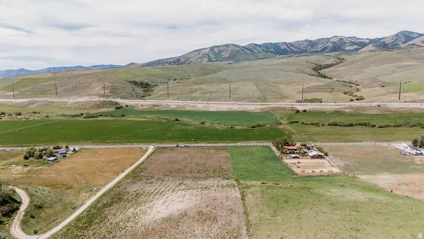 Expansive acreage featuring varied agricultural fields and distant mountain ranges