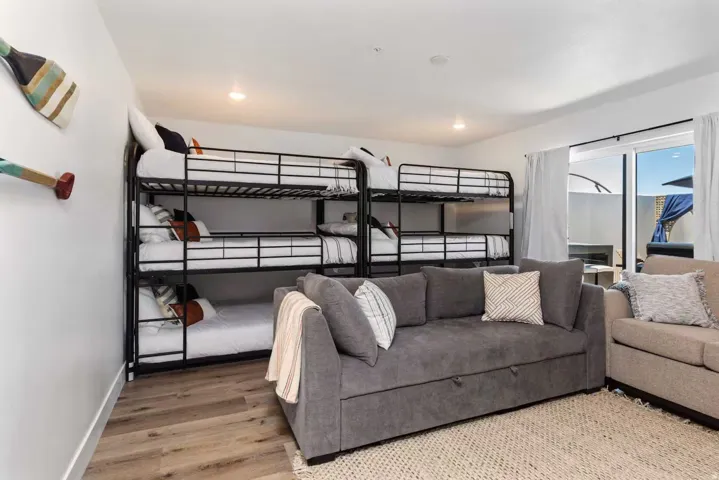 Bedroom with light wood finished floors and recessed lighting